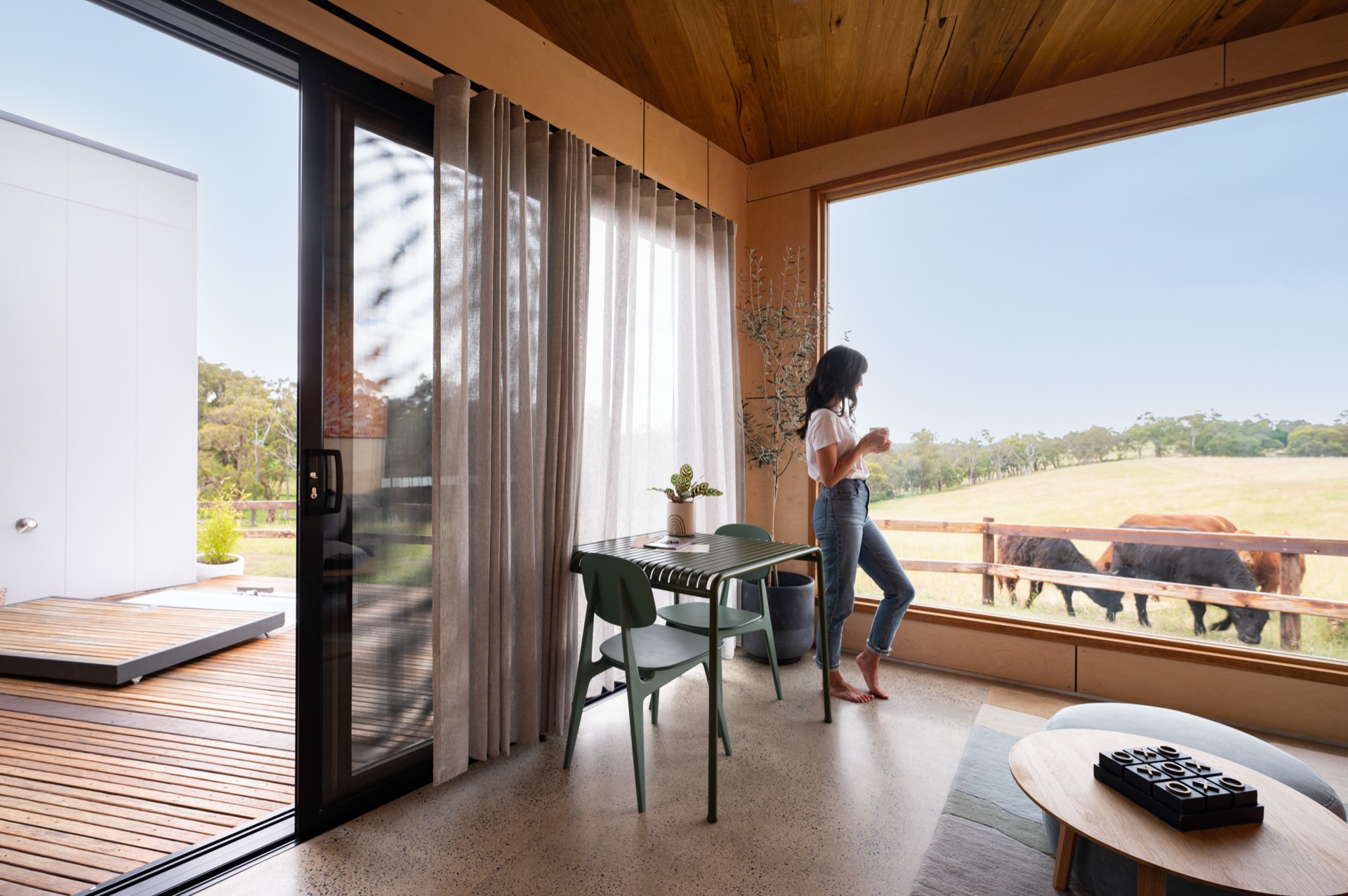 Inside Casa Luna — warm timber and floor-to-ceiling windows